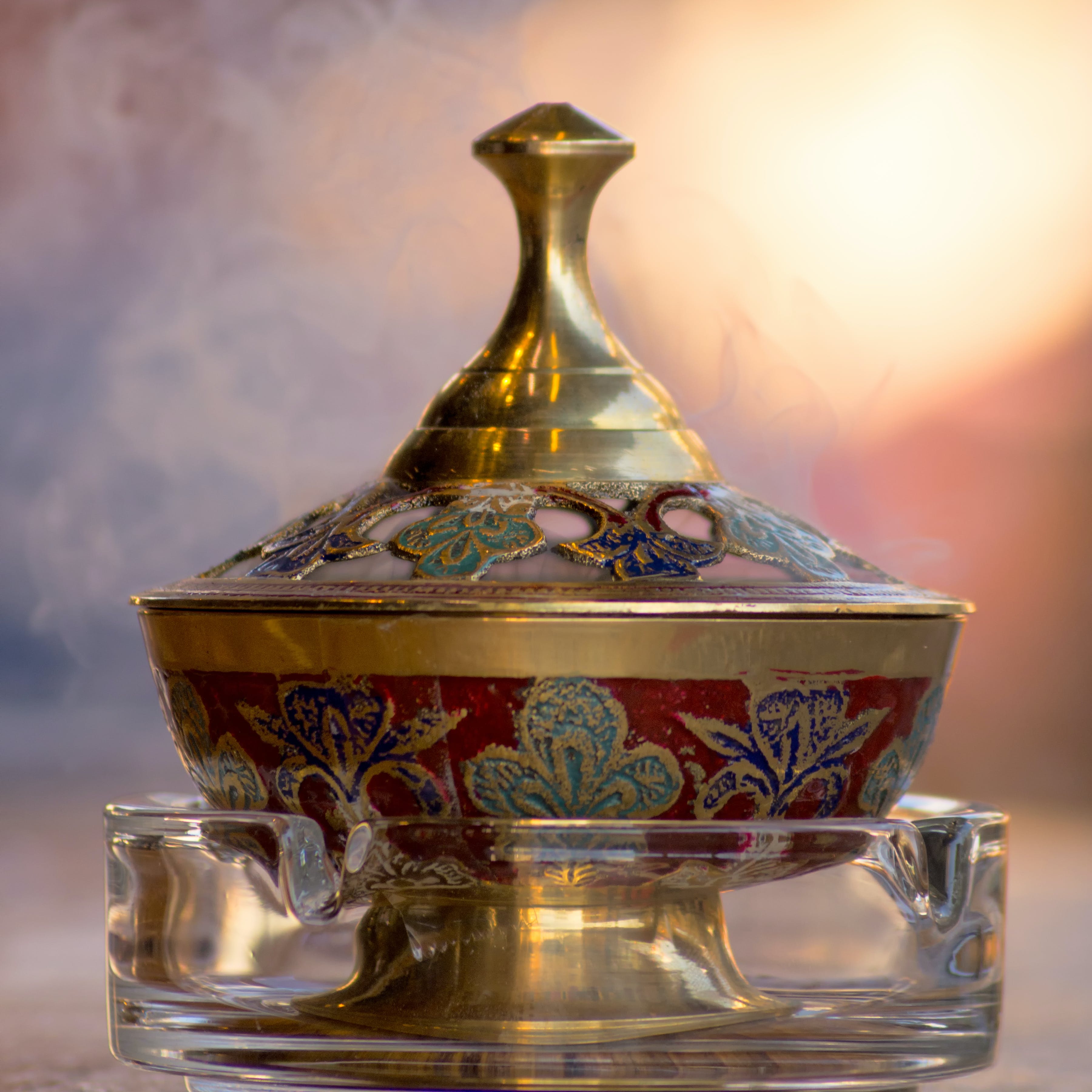 Handcrafted Middle Eastern incense burner with rising aromatic smoke symbolizing the region's rich heritage and spiritual connection.